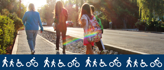kids and adult walking on sidewalk next to roadway. Icons of people walking, biking, and in a wheelchair.