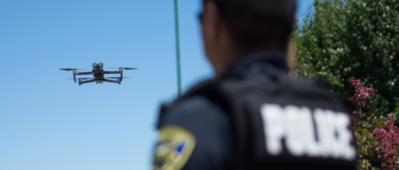 police officer standing near drone flying