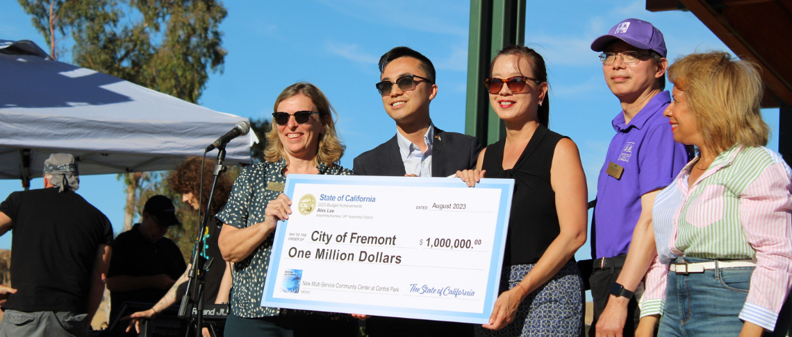 Assemblymember, Mayor, Councilmembers, and City staff holding a $1 million check for funding for new multi-use community center at Central Park