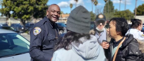 Police Chief talking to community members at an outdoor event