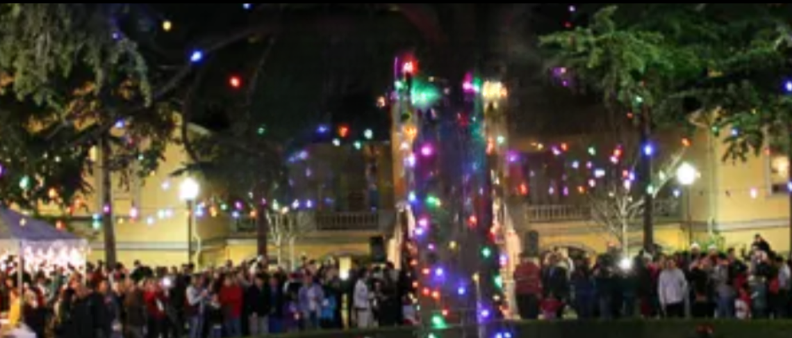 tree lighting in Mission San Jose Courtyard with community members mingling