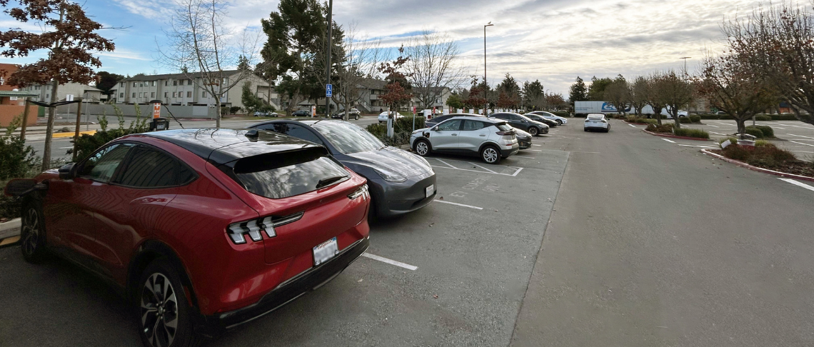 electric vehicles in parking stalls in parking lot