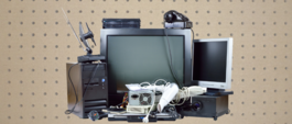 electronic waste to recycling including old television, computer equipment, hairdryer, phone, and antennae.