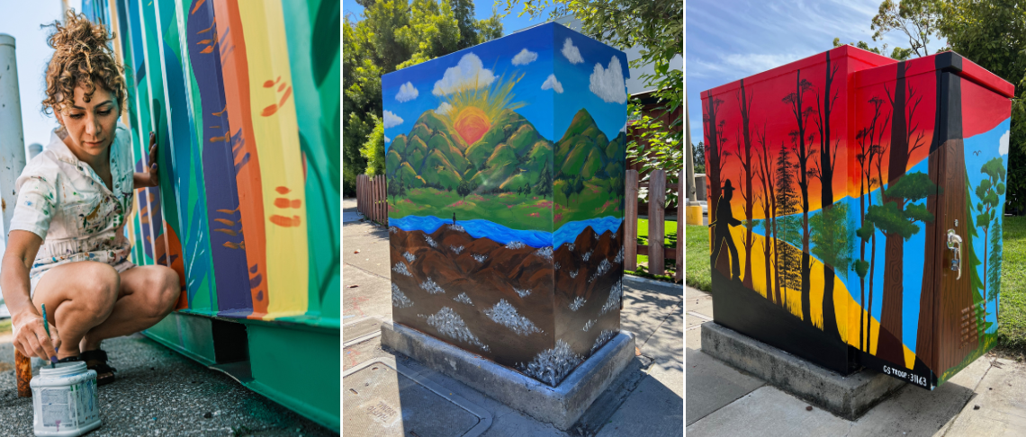 artist painting a traffic signal control box next to fully painted ones in bright colors and designs.