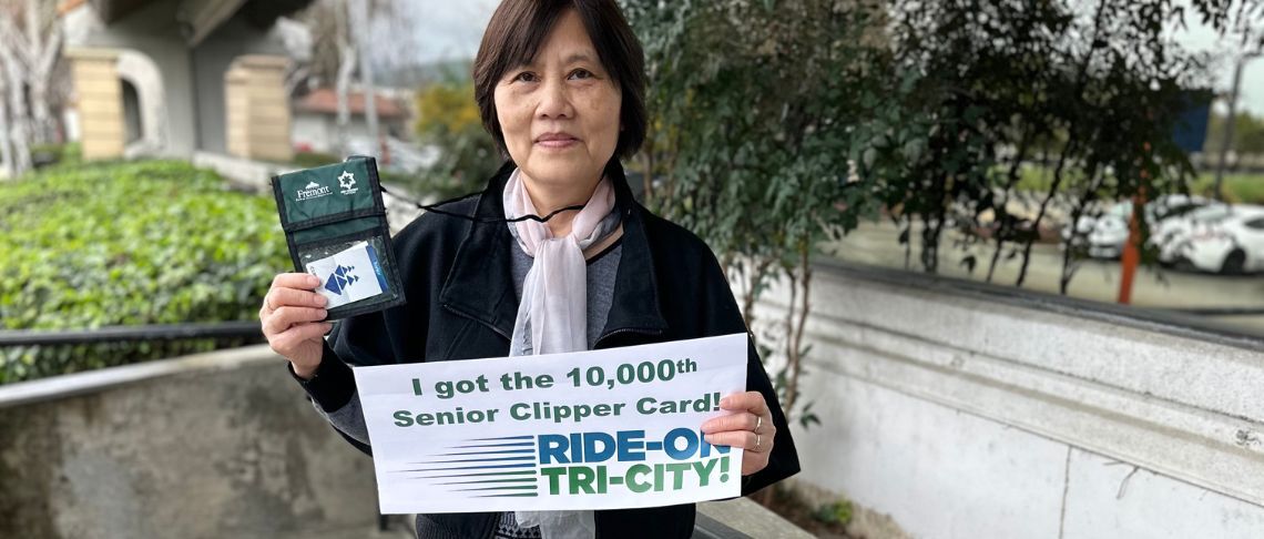 recipient holding the 10,000th Senior Clipper Card sold