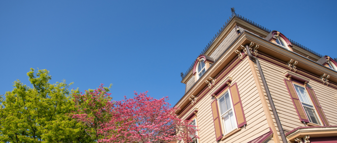 Corner of historic building roof against a blue sky