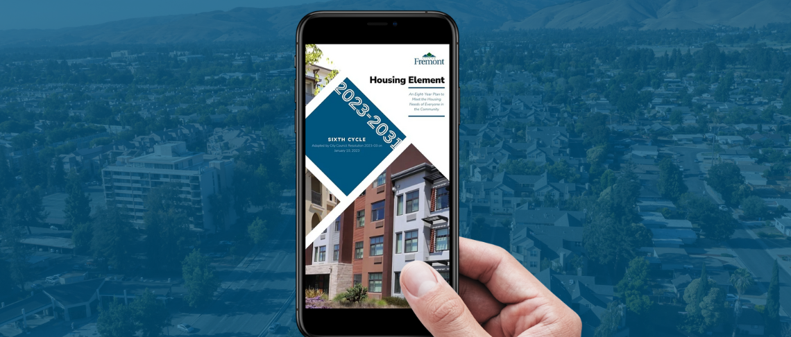 Holding a smartphone with Housing Element info text