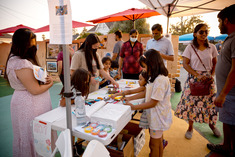 Families visiting an artist vendor booth