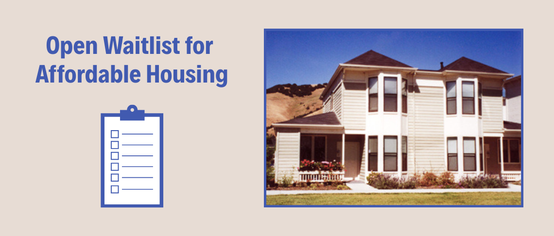 Two-story duplex with front landscaping and blue sky in the background