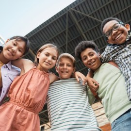 Youth smiling and linking arms