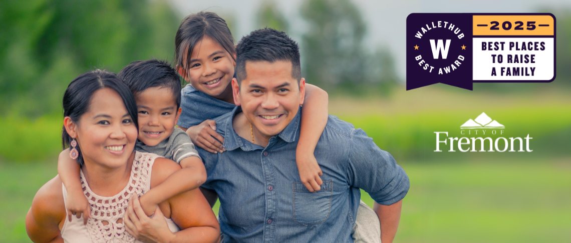 A smiling family of two parents and two kids