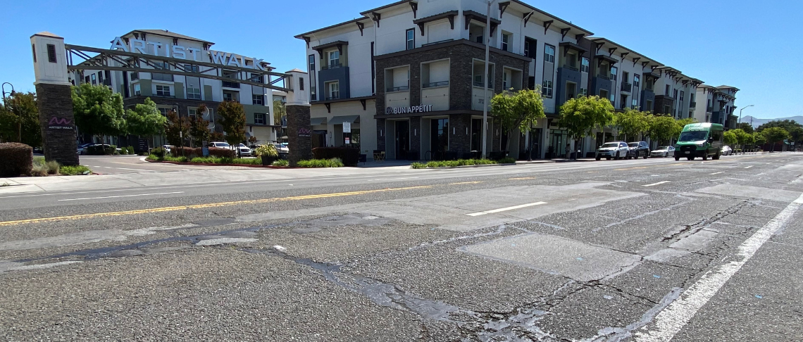 Fremont Boulevard pavement with Artist Walk mixed use project in background