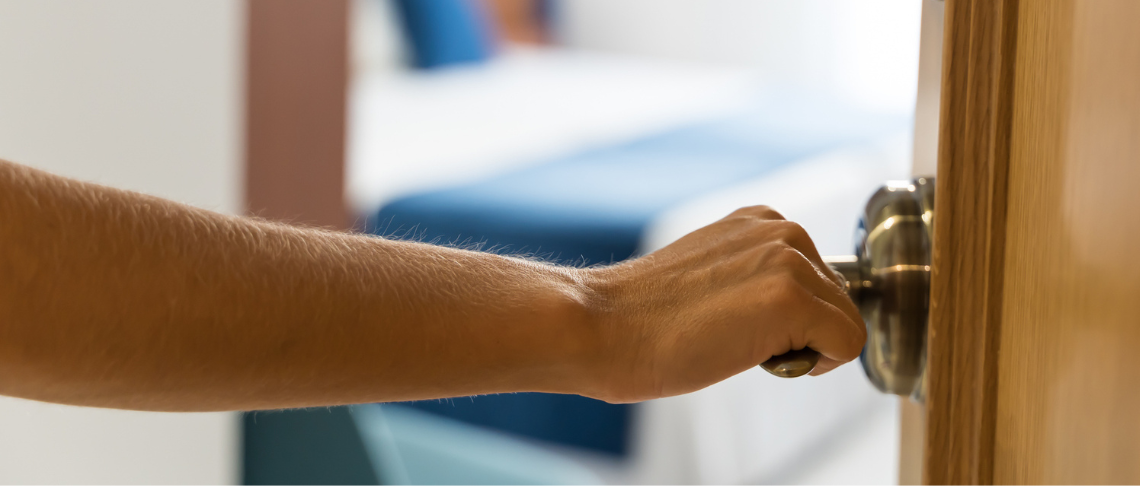 Person opening a doorknob