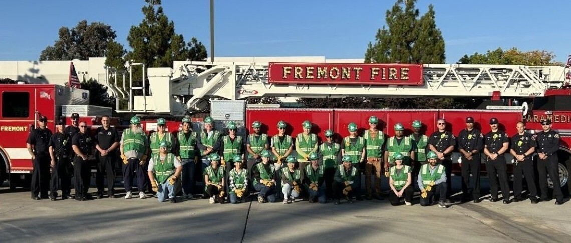 Fire Department personnel and trainees in front of red Fremont fire truck