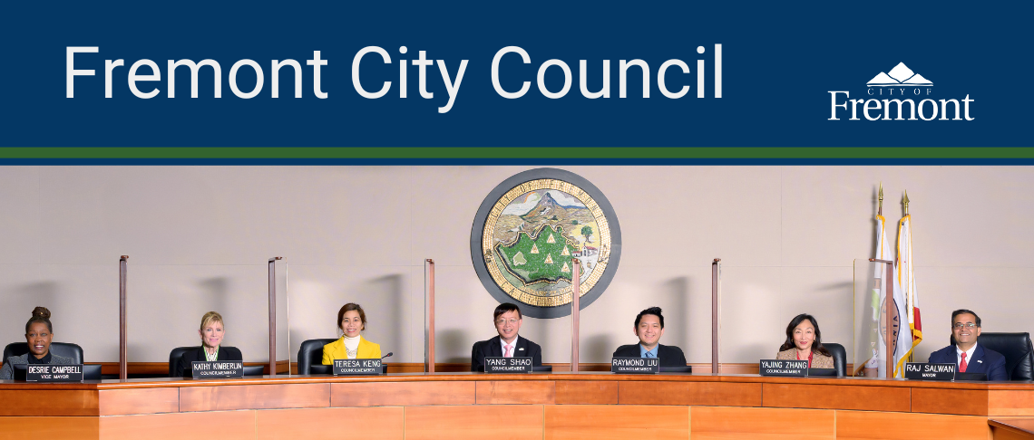 Fremont Mayor and City Councilmembers sitting at dais in Council Chambers with City Seal artwork behind them.