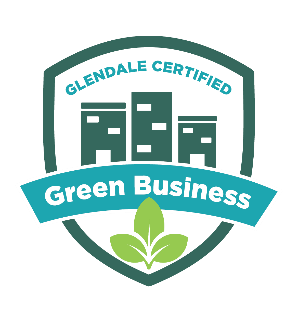 A shield outline in greed with three tall building silhouettes; Text: "Green Business" 