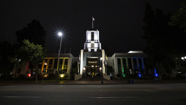 Exterior photo of City Hall lit up with Pride Color (Rainbow)