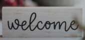 A sign with the word "Welcome" written on it