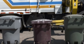 A Glendale Waste Pickup Truck in the background with the trash bins in the front