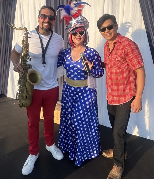 DJ Darla Bea with saxophonist Gerry Smith Jr. and line dance instructor Tin