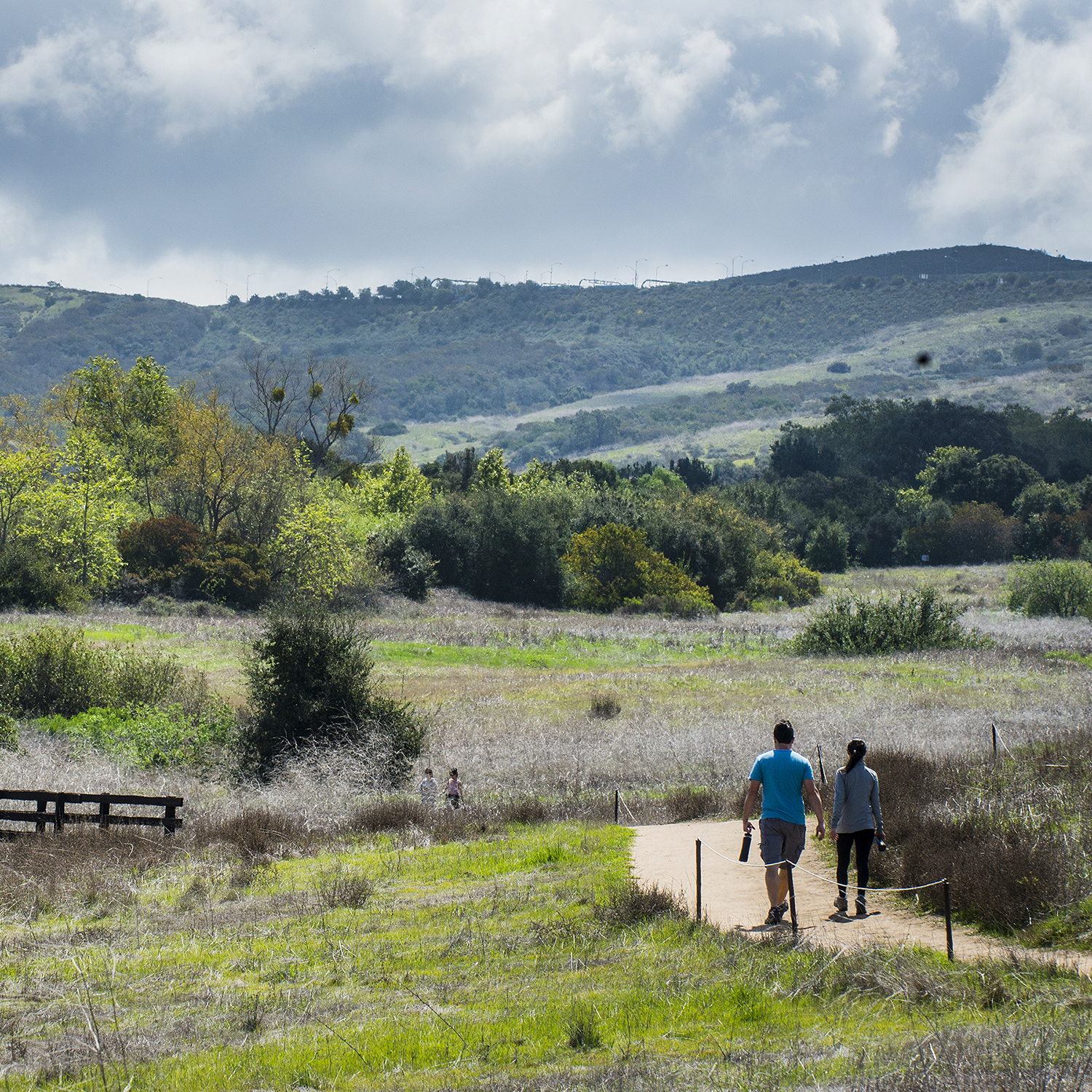 Two people walking on a trail