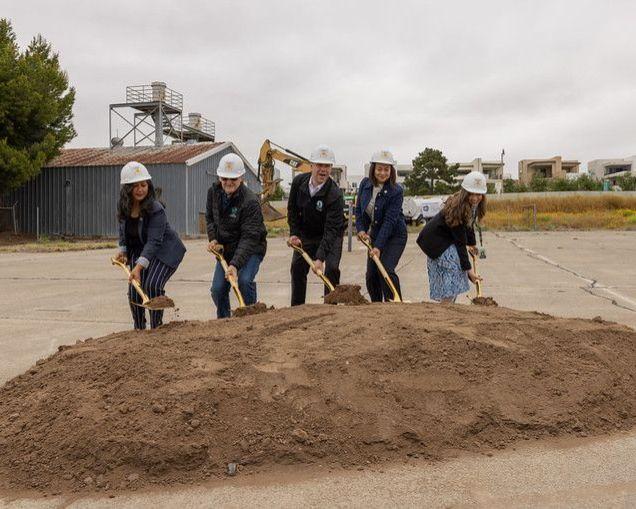 Irvine City Councilmembers shovel a pile of dirt at the groundbreaking for the Great Park