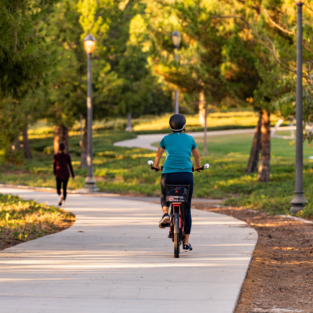A woman riding her bike on a trail during golden hour