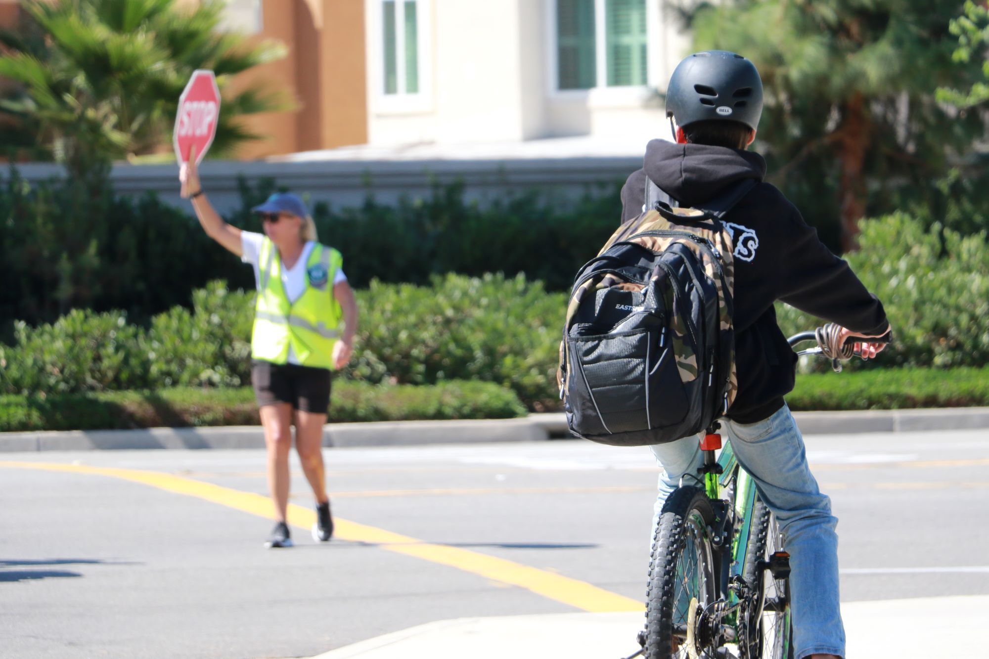 student riding bike through crosswalk
