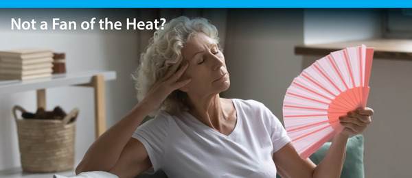 women using fan in the heat
