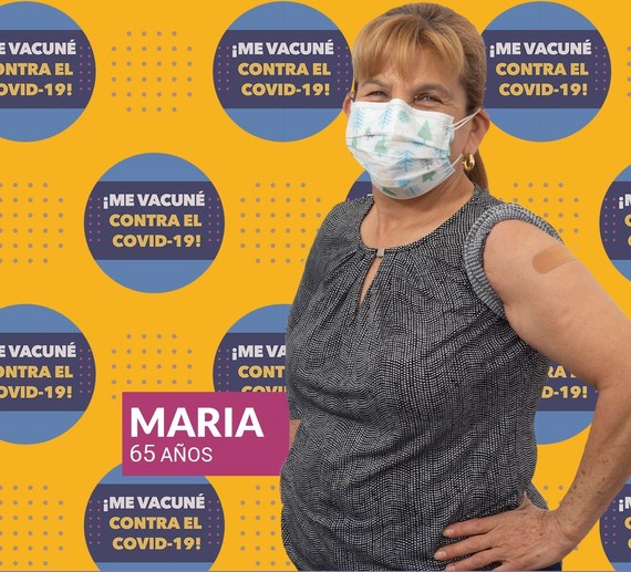 Community member Maria proudly shows off her arm where she was vaccinated.