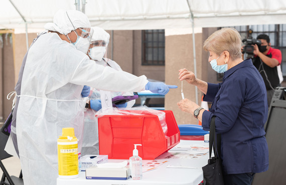A community member receives a COVID-19 test kit.