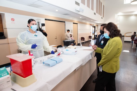 Board Chair and Supervisor Hilda L. Solis with Al Ballesteros from JWCH Institute, Inc. at the Bell Community Vaccination Center
