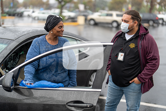 LAHSA member engaging with Karen who is living out of her car. LAHSA conducts outreach work for a Pathway Home operation in Pomona.