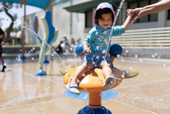 Families enjoying an LA County Splash Pad at Adventure Park