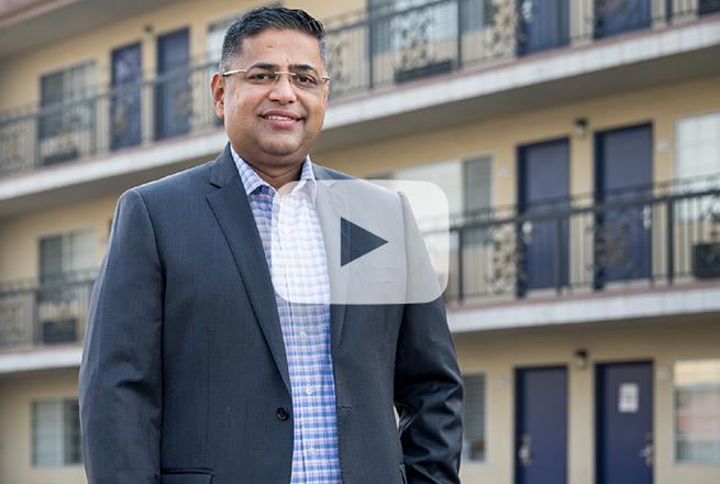 Man in front of motel building