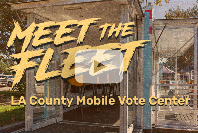 Glass doors open to a trailer mobile vote center with electronic voting machines inside