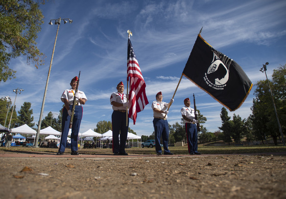 Men and Women holding flags and weapons of the U.S. Marine Corps League Detachment #1347 presents the colors during the veterans day ceremony