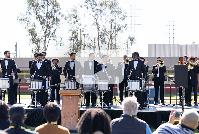 Group of men in black tuxedos playing the drums at the Barry J. Nidorf Secure Youth Treatment Facility in Sylmar