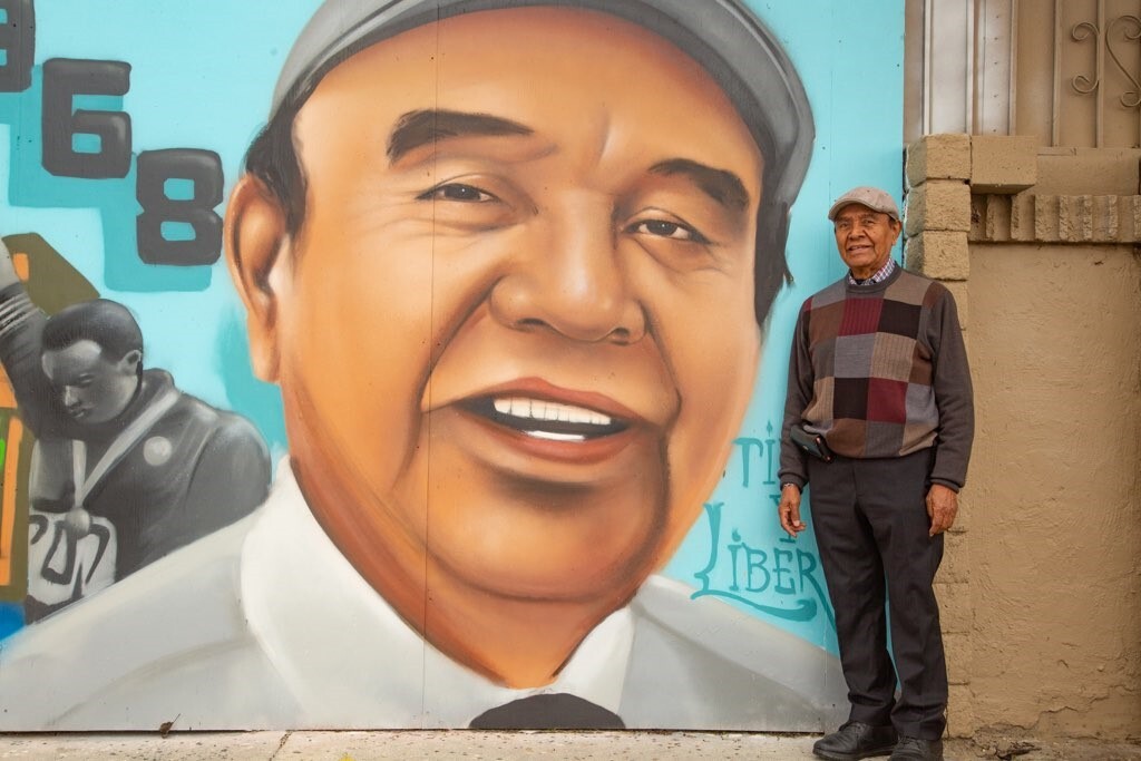 Arturo Ybarra Stands Alone at Unity of the Sun Mural in Watts
