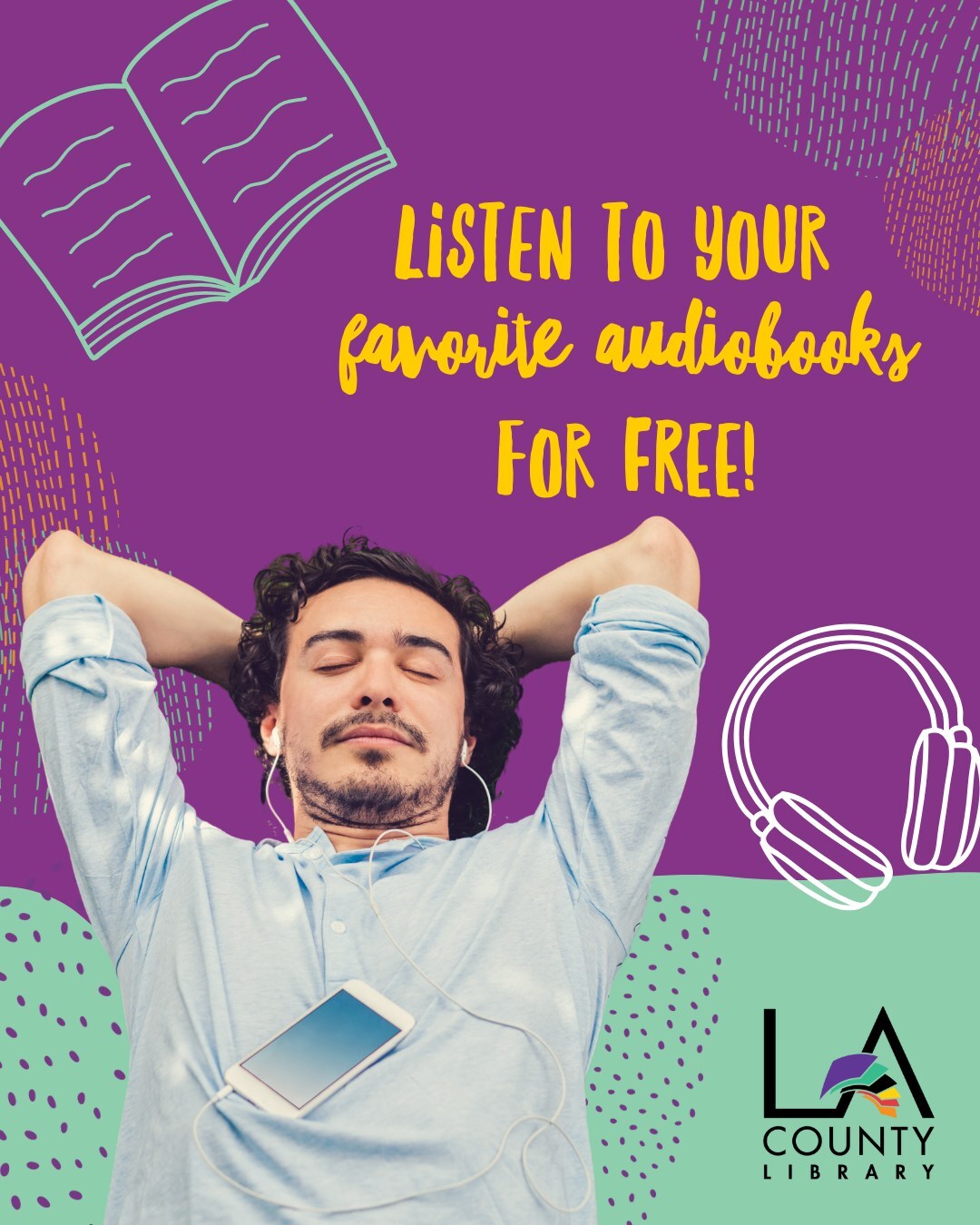 Man with curly hair, beard and blue shirt is laying down with his wired earphones on and his cellphone on his chest