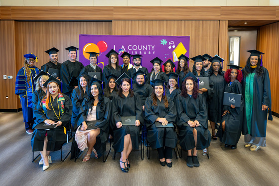Group of men and women with their cap and gown holding their diploma