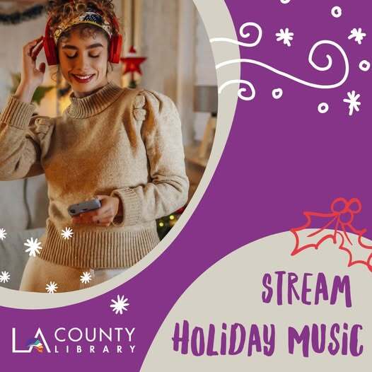 Woman wearing headphones listens to music while holding cellphone