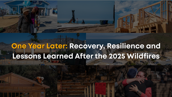 Two people standing in front of blue house, wooden frame of house, construction worker, beach with property debris, and folks hugging