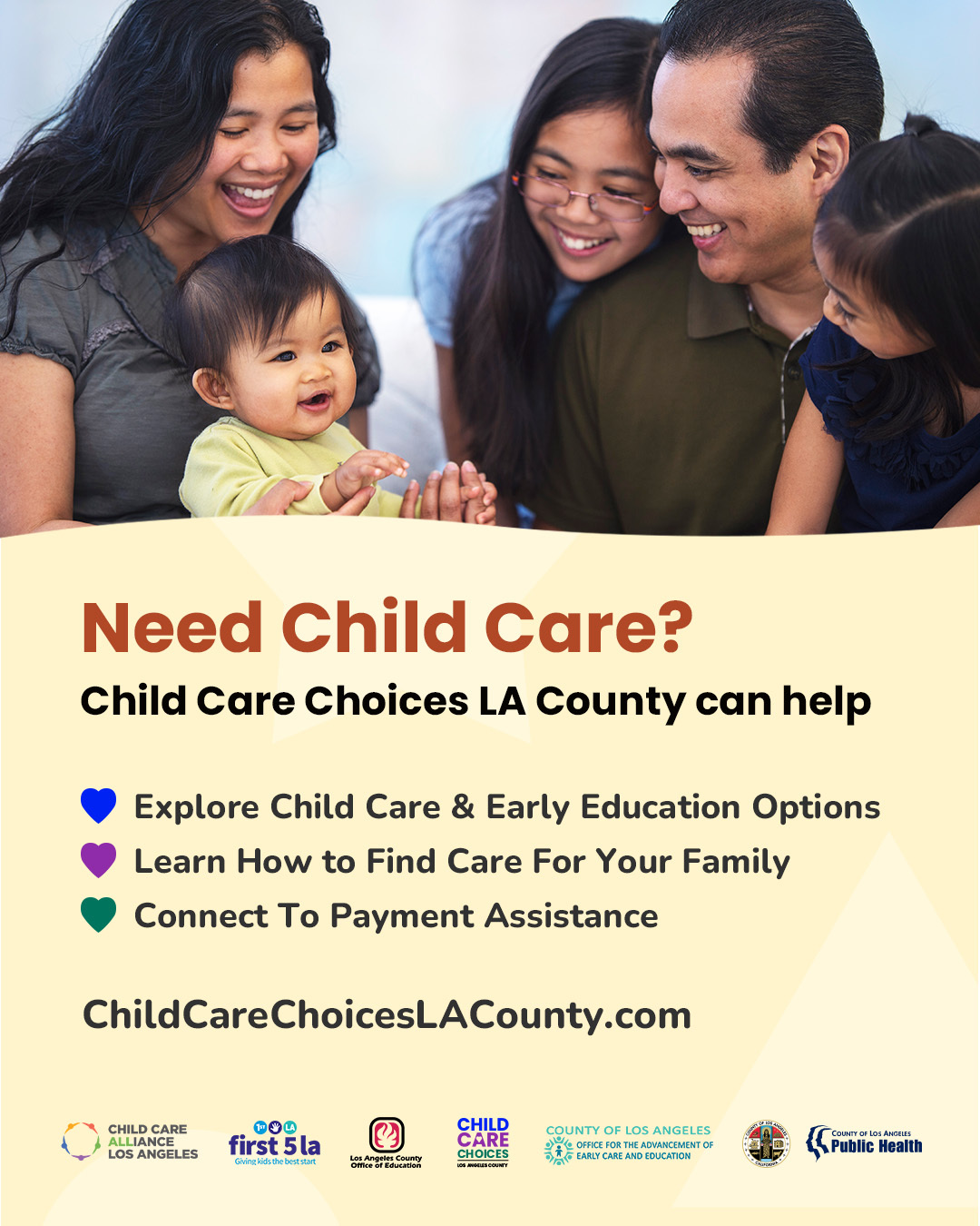 Woman holds baby, and man sits next two them with two young girls