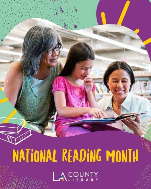 Two women and a girl looking at a book at the library with shelves full of books in the background