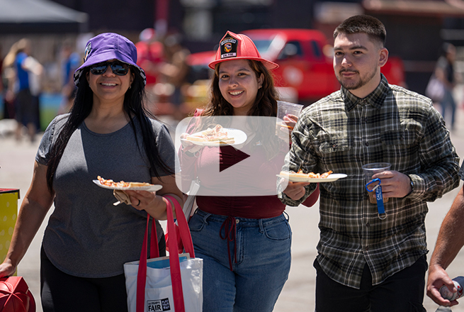 Two women and a man walking with drinks and food in their hands at the LA County Fair