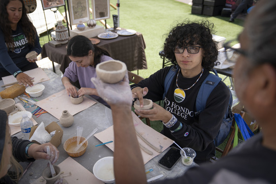 Male and female students making pottery at Department of Mental Health Take Action event at Rio Hondo College