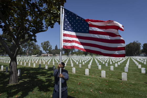 Man raises United States flag at Los Angeles National Cemetery 