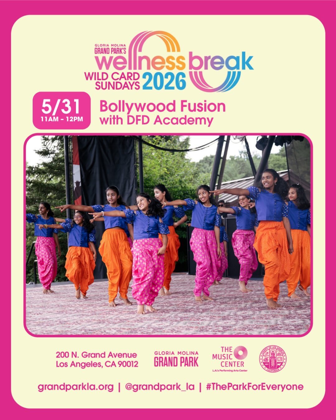 Girls dressed with baggy orange and pink pants with blue blouses that are dancing