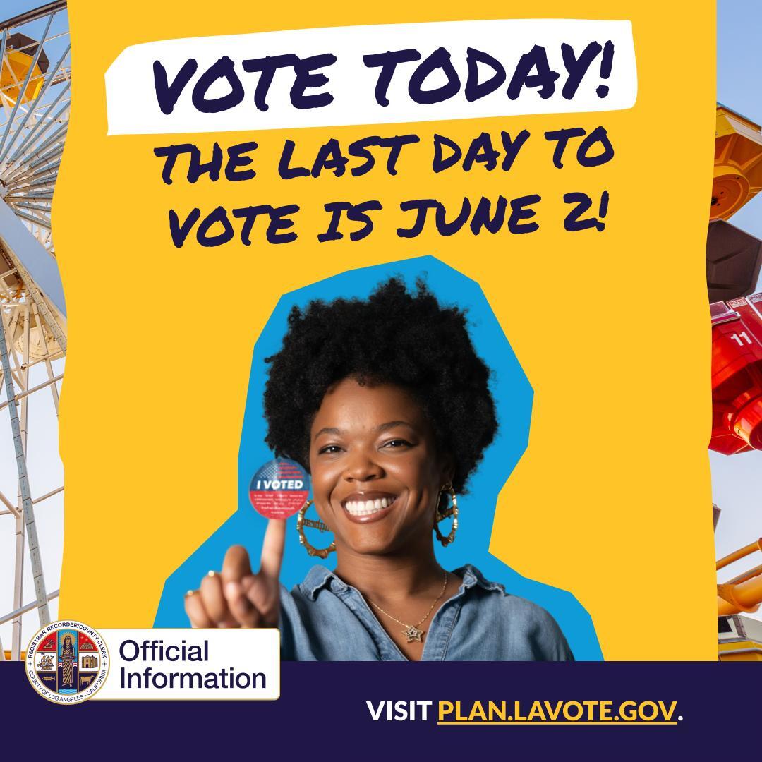 Woman smiling as she holds up on her index finger a "I Voted" sticker and the Santa Monica Ferris wheel in the background